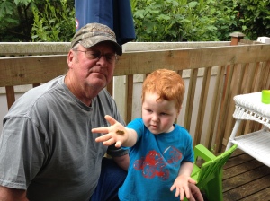 LJ showing Grandpa Louie his caterpillar
